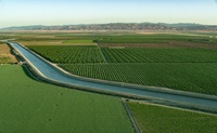The aerial view looks south toward the California Aqueduct near Jenson Avenue and the Panoche Creek Shipon in the agricultural rich Central Valley of Fresno County, California. The aqueduct is a critical part of the State Water Project that carries water from the Sacramento-San Joaquin Delta to the San Joaquin Valley and Southern California. Photo taken May 13, 2023.