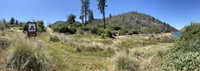 A photo of the vegetated hillside at the newly restored Craig Saddle Boat-in Campground with Lake Oroville in the background.