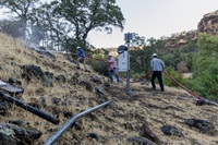 California Department of Water Resources’ Surface Water Investigations Section staff spray the ground with water in preparation to relocate a stream gage to higher ground near Red Bluff in Tehama County, California, to protect the equipment from being inundated during high flows. Photo taken August 20, 2025.