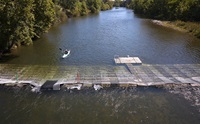 A kayak prepares to cross the Feather River Fish Monitoring Station located in Oroville, California, part of Butte County, August 23, 2023. The fish monitoring station will provide information on abundance, run timing, and origin (hatchery or natural) of steelhead and Chinook salmon populations in the Feather River that will be used to enhance fisheries management.