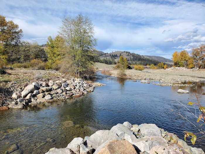 Confluence of Sugar Creek with the main stem Scott River, with rocky banks and autumn trees.