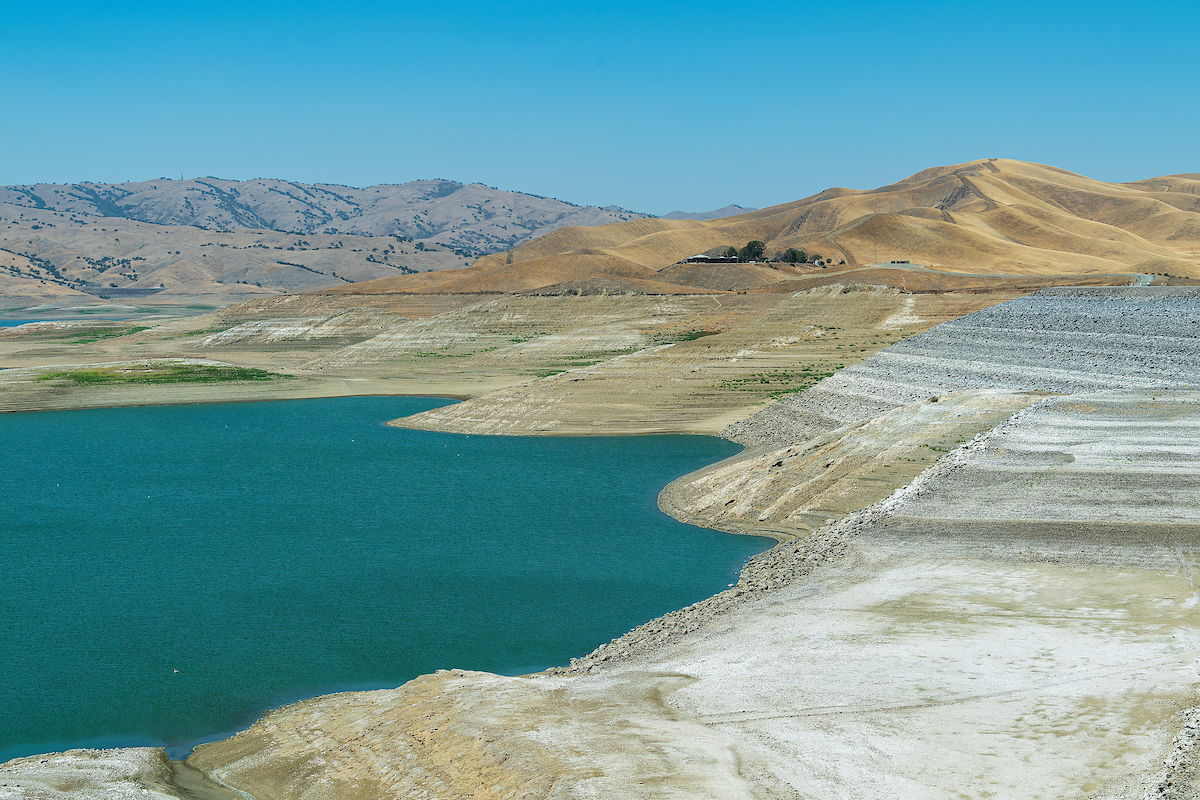 The white roofs of the Romero Visitor Center are seen in this photograph of the San Luis Reservoir in Merced County at a time of relatively low water levels. Photo taken August 10, 2021.