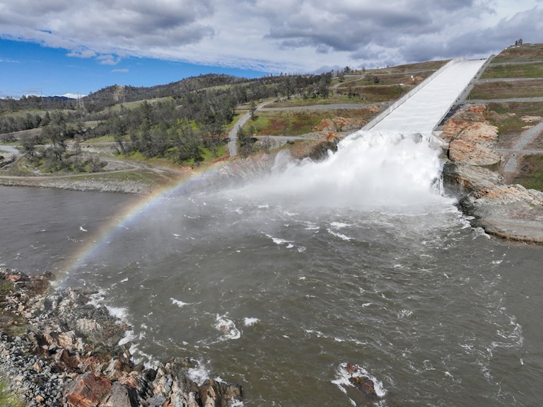 A drone provides an aerial view of the small cloud mist formed as water flows over the four energy dissipator blocks at the end of the Lake Oroville main spillway. The California Department of Water Resources increased the water release down the main spillway from 4,000 cubic feet per second (cfs) to 8,000 cfs. Main spillway releases will continue to manage lake levels in anticipation of rain and snowmelt. Photo taken March 10, 2023.