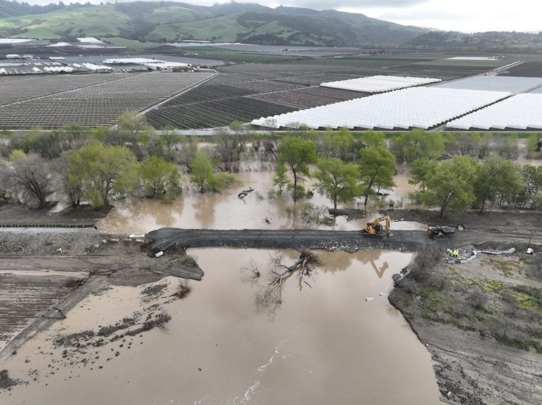 A drone provides a view of construction equipment placing rock to close a levee break caused by floodwaters from the Pajaro River near the township of Pajaro in Monterey County, California. The floodwater breached the levee around midnight on March 10, 2023.