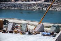 Workers prepare four energy dissipator blocks for new concrete surfaces on the lower chute of the Lake Oroville main spillway.