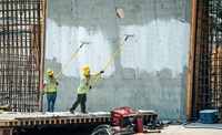 Workers applying cure onto new concrete sidewall of the Lake Oroville main spillway