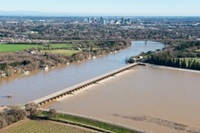 The Sacramento Weir opens its gates to flood the Sacramento Bypass Wildlife Area in Yolo County, Calif. on January 13, 2017.