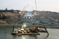 The sun rises over the Lake Oroville flood control spillway and diversion pool while crews continue with the recovery efforts at the Butte County, California site.