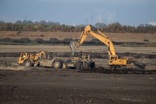 Construction equipment removes sand from a borrow pit to be place at the Dutch Slough Tidal Marsh Restoration Project in the Sacramento-San Joaquin Delta implemented by the California Department of Water Resources.