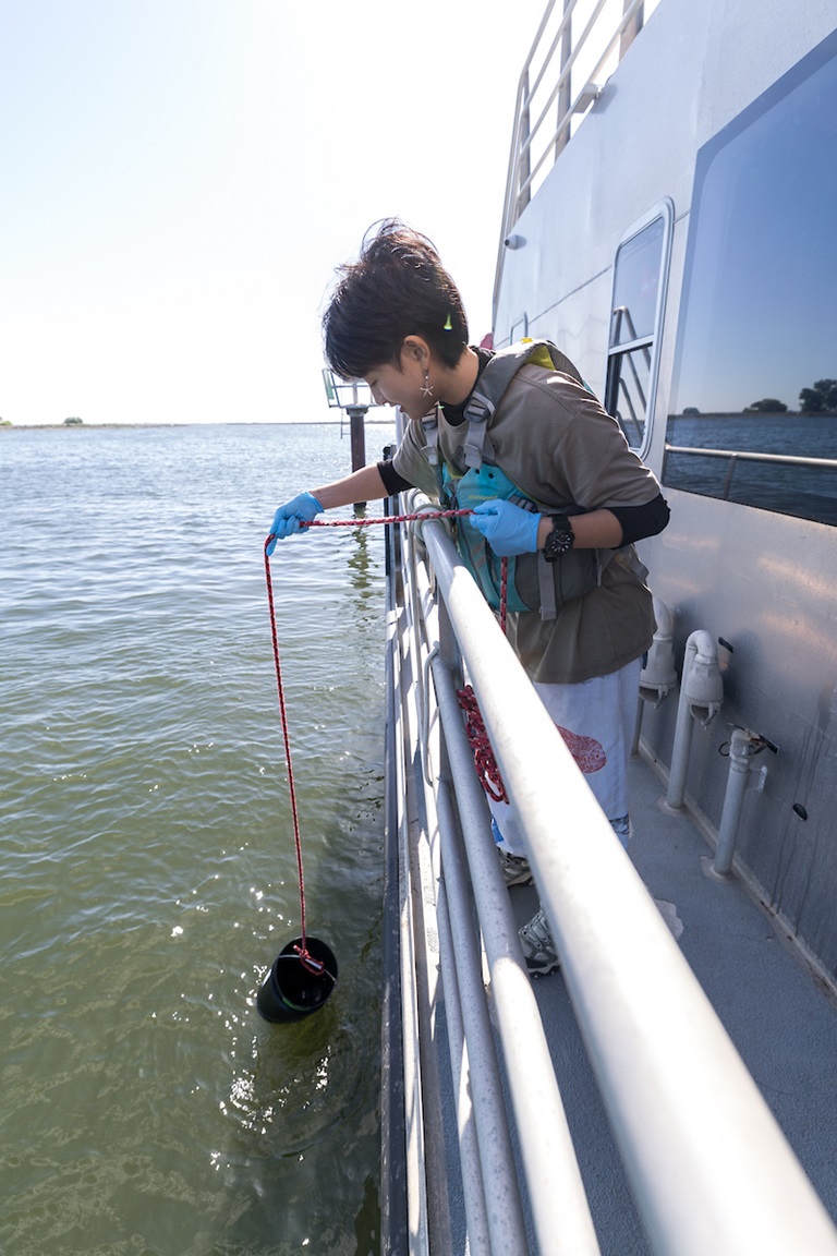 California Department of Water Resources Assistant Estuarine Ecologist Kristina Nguyen collects samples from the Delta as part of the DWR Multitrophic-Level Metabarcoding (MTLM) program.