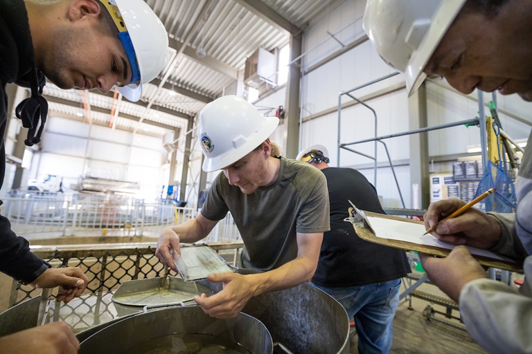 California Department of Water Resources Utility Craftsworkers (from left) Julian Lemus, Paul Bronson and David Martinez count and measure young fish during a count in a fish holding tank building at the John E. Skinner Delta Fish Protective Facility in Contra Costa County, California. Photo taken June 4, 2024.