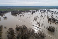 A drone view of floodwaters from the Sacramento River overtopping the Fremont Weir in Yolo County, California.