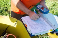 Glen Gordon, engineering geologist with the California Department of Water Resources, measures groundwater levels at a designated monitoring well in Colusa County on March 17, 2016.