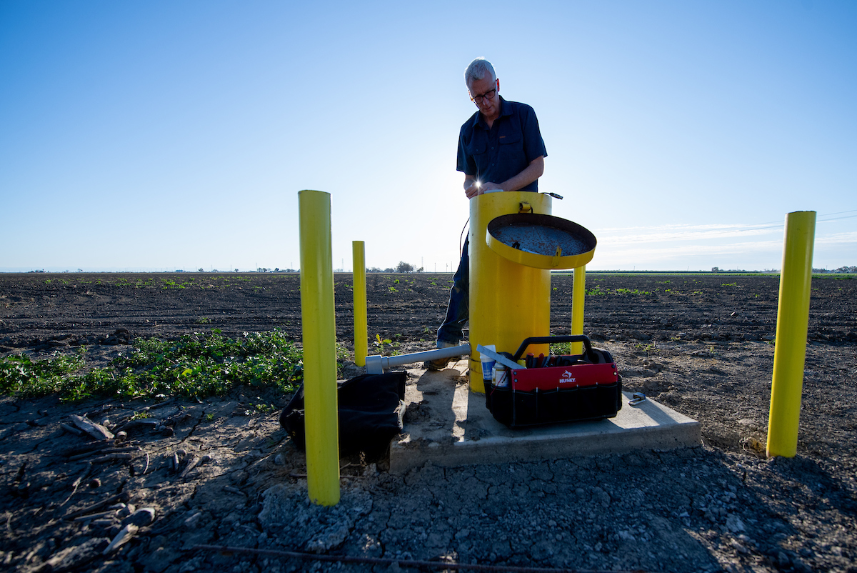 Aaron Cuthbertson, DWR engineering geologist measures groundwater levels at designated monitoring wells in Yolo County on March 10, 2020. 