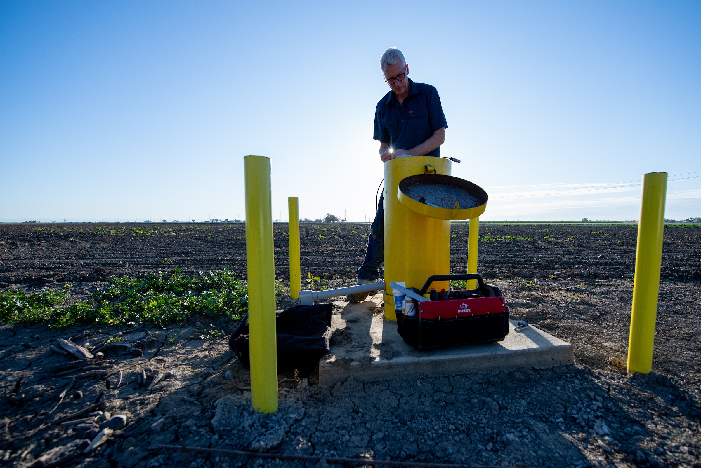 Aaron Cuthbertson, engineering geologist with the California Department of Water Resources, measures groundwater levels at designated monitoring wells in Yolo County on March 10, 2020.