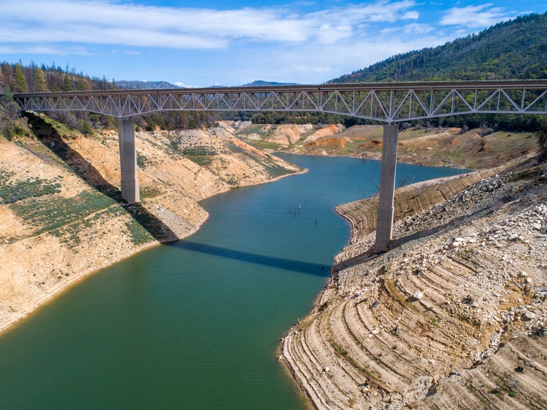 An aerial drone view showing low water under the Enterprise Bridge at Lake Oroville with a water elevation of 743 feet on March 17, 2022 in Butte County.