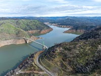 A drone view of low water conditions at the Bidwell Bar Bridge located at Lake Oroville in Butte County, California. On this date, the water storage was 1,790,095 acre-feet (AF), 51 percent of the total capacity. Photo taken January 12, 2022.