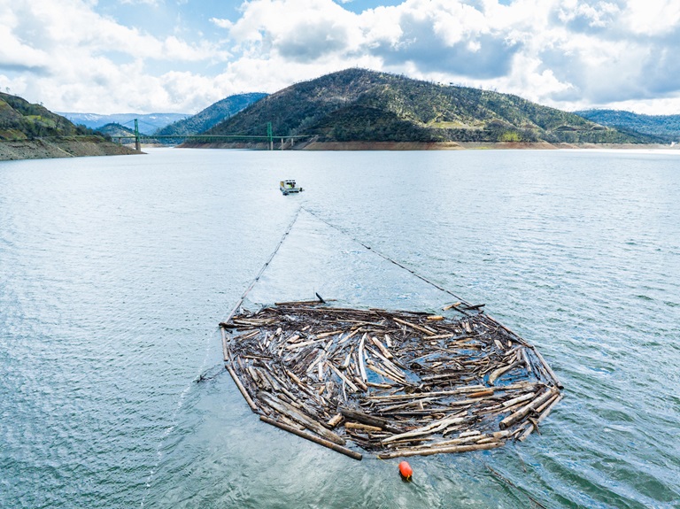 Driftwood is collected and towed in pods with boats throughout Lake Oroville in Butte County, California. Photo taken March 7, 2023.