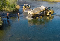 A drone photos shows contractors working on a California Department of Water Resources project placing approximately 8,000 cubic yards of in-river spawning gravel to improve existing Chinook salmon and steelhead spawning habitat sites along the low-flow channel of the Feather River in Oroville, Butte County. Photo taken August 6, 2026.