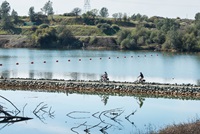 Two cyclists ride along the Brad Freeman Bike Trail, which is built along the Thermalito Diversion Pool in Oroville, CA.