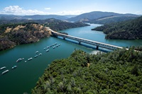 An aerial view of the Highway 70 bridge crossing over the Lake Oroville Marina, showing Lake Oroville.