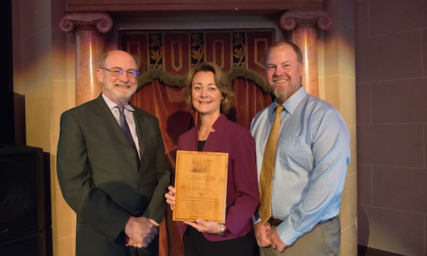 From left, John Laird, Secretary of the California Natural Resources Agency, Cindy Messer, Chief Deputy Director of the California Department of Water Resources, and Bryan Brock, DWR Sr. Engineer, stand with the Outstanding Environmental Project Award for Twitchell and Sherman Islands carbon sequestration, subsidence reversal, and wetlands, during the San Francisco Estuary Conference in Oakland, California.