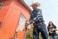 From left, homeowners Leonicio Ramirez and his daughter Tania Ramirez are the first residents to receive water through a water distribution system in East Porterville, Calif.  on August 19, 2016. 