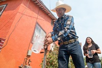 From left, homeowners Leonicio Ramirez and his daughter Tania Ramirez are the first residents to receive water through a water distribution system in East Porterville, Calif. on August 19, 2016.