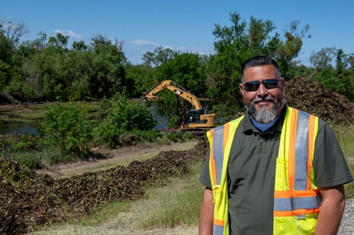 Joel Farias, superintendent with California Department of Water Resources (DWR), works onsite while DWR’s Flood Maintenance and Operations Branch, working with scientists from the California Department of Fish and Wildlife, performs aquatic vegetation removal from the borrow canals of the Sutter Bypass to clear a migration pathway and improve water quality for migrating adult spring-run Chinook salmon, which will also rescue fish stranded below these barriers.