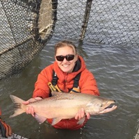 DWR environmental scientist Nicole Kwan  with fish. 