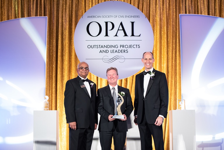 State Water Project Acting Deputy Director Ted Craddock (center) holds Outstanding Leader award presented by the American Society of Civil Engineers leaders in March of 2020. The Oroville Dam Spillways Reconstruction Project won the Outstanding Project award.