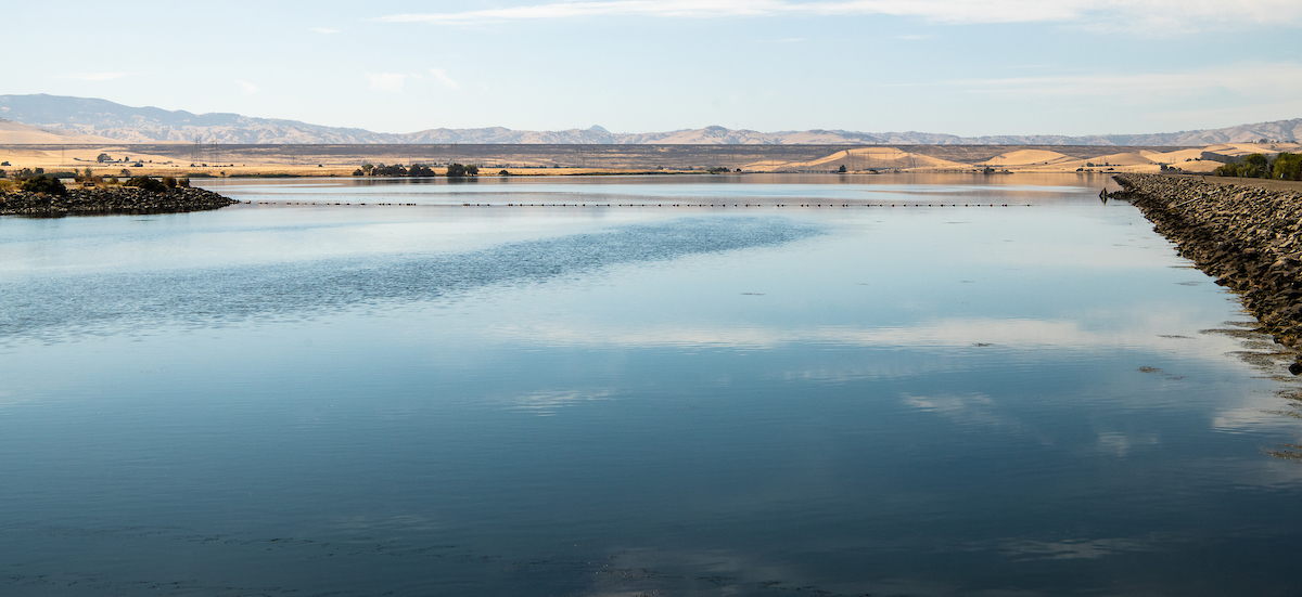 In the foreground is O'Neill Forebay, and in the background is B. F. Sisk Dam (also known as San Luis Dam), a major earth-filled dam in Merced County, California, which forms San Luis Reservoir, the largest off-stream reservoir in the United States. 