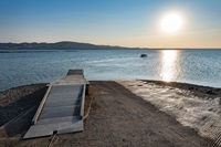 Fishermen head out from this dock near Dinosaur Point on the San Luis Reservoir near dawn in Merced County on Aug. 23, 2021.