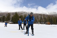 DWR employees measure snow at Philips Station during the fourth snow survey of the season. 