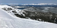 View of snow covered Sierra Nevada mountains in Nevada County, California.