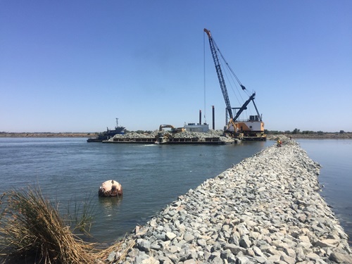 The Emergency Drought Barrier shown during construction in the Sacramento-San Joaquin Delta at West False River. The temporary 800-foot wide barrier is to control water salinity into the Delta and preserve water in upstream reservoirs. 