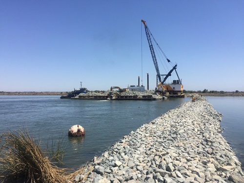 The Emergency Drought Barrier shown during construction in the Sacramento-San Joaquin Delta at West False River. The temporary 800-foot wide barrier is to control water salinity into the Delta and preserve water in upstream reservoirs.