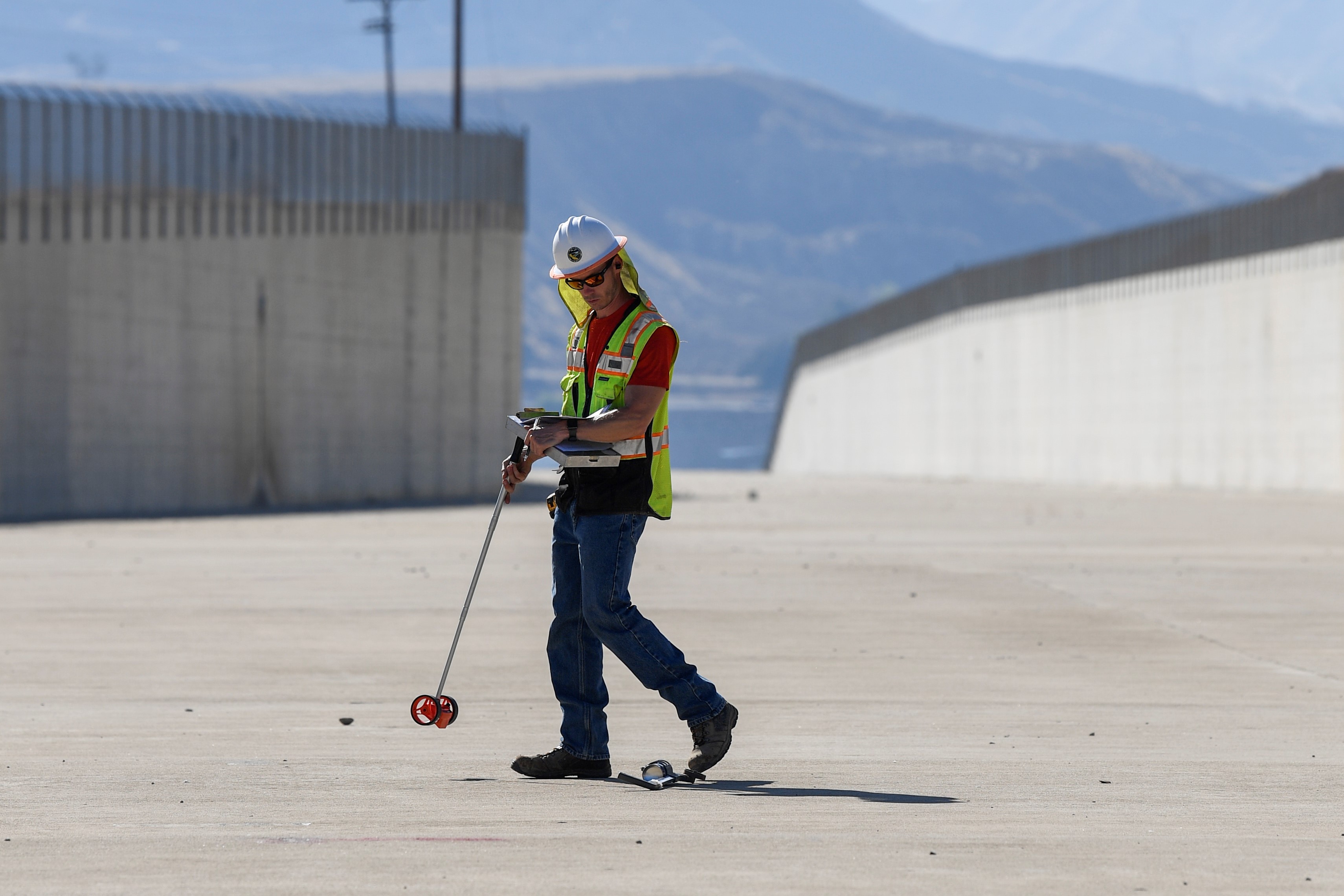DWR engineering geologist Chris Silva marks drill hole locations for initial assessments at Castaic Dam’s spillway in Los Angeles County.
