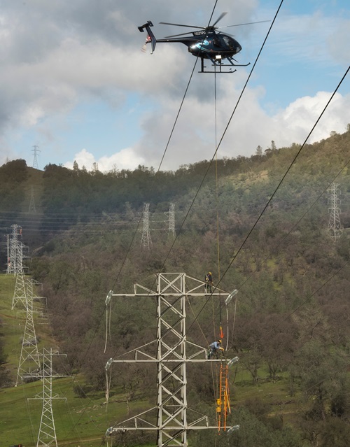 Pacific Gas and Electric Company work the power lines near the base of the emergency spillway at Lake Oroville in Oroville Calif.