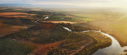 Image showing an aerial view of the confluence of the Sacramento and Feather rivers, northwest of Sacramento, California. Vast agricultural lands extend from the confluence to distant mountains.