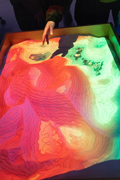 Photograph showing an augmented-reality sandbox during groundwater week. 
