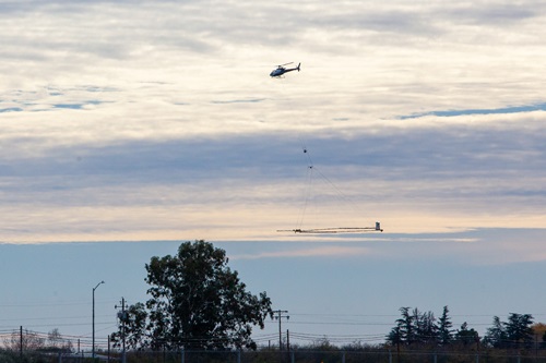 A helicopter performing Airborne Electromagnetic Survey