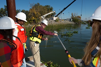 DWR employees install a pipe to improve the Curtis Landing Fish Release Site at Sherman Island in Rio Vista, CA.